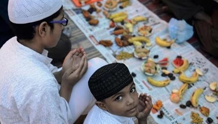 This image shows that two children are praying at the time of breaking the fast.—AFP/File