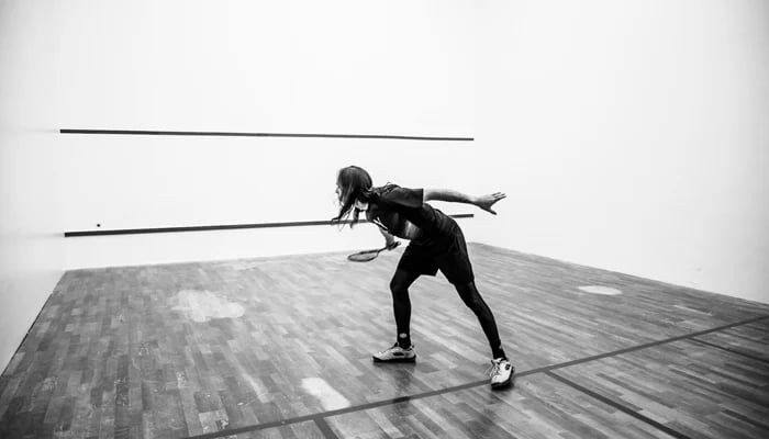 This representational image shows a female player during a squash game. — Unsplash