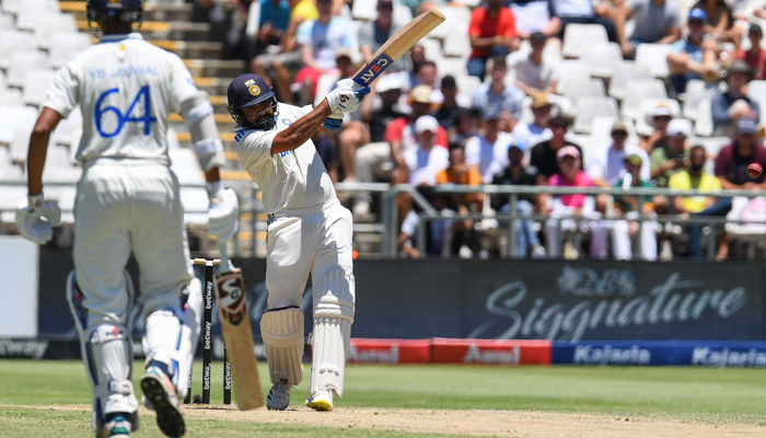 Indias Rohit Sharma (R) hits a four during the second day of the second cricket Test match between South Africa and India at Newlands stadium in Cape Town on January 4, 2024. — AFP