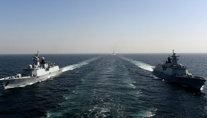 Pakistan Navy Ship Taimur (L) and Tughril (R) take part during the multinational naval exercise AMAN-23 in the Arabian Sea near Pakistans port city of Karachi on February 13, 2023. — AFP