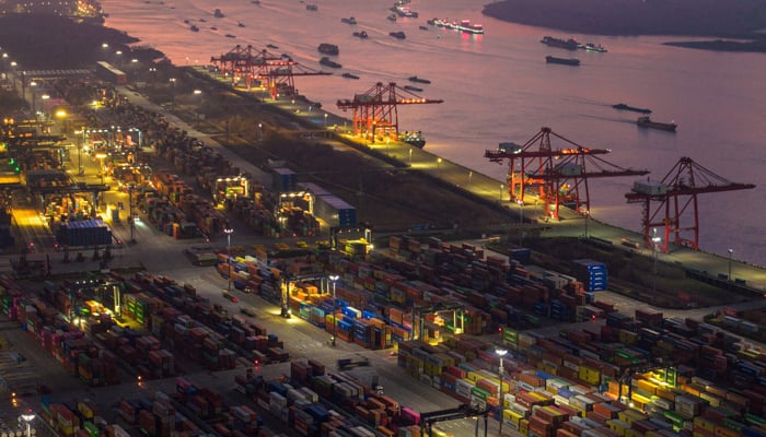 The aerial photo taken on January 4, 2023 shows shipping containers stacked at Nanjing port in Chinas eastern Jiangsu province. — AFP