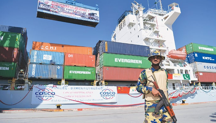 A navy man stands guard in front of a ship at the Gwadar port during a ceremony on Sunday to mark the start of trade activities under the China-Pakistan Economic Corridor. —AFP/File