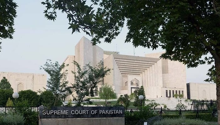 The Supreme Court Of Pakistan board can be seen outside the Supreme Court building. — AFP/File
