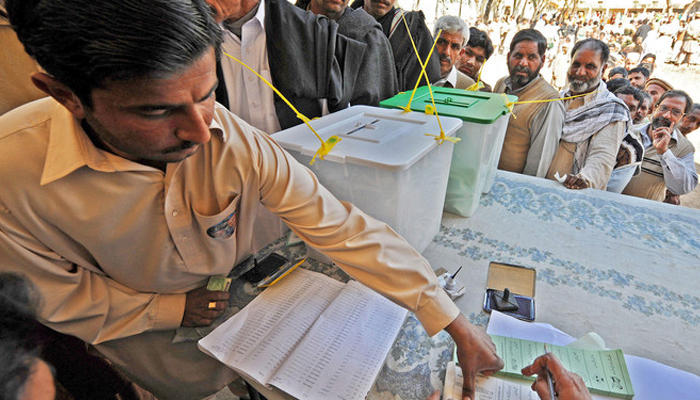 Pakistani voters wait to cast their votes at a polling station in Sialkot, Pakistan.— AFP/File