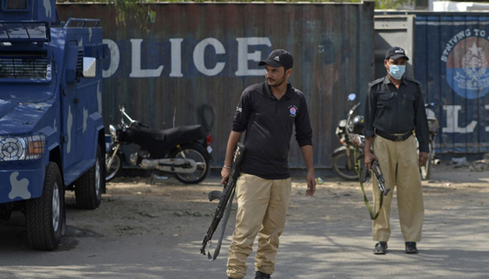 Police officials stand guard on a street. — AFP/File