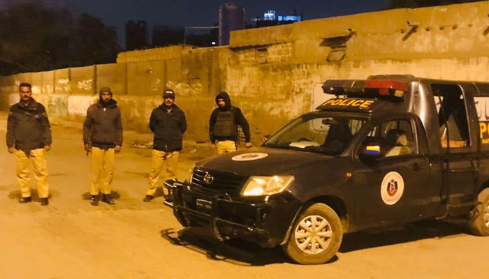 Karachi Police stand guard next to the police vehicle in Karachi on January 6, 2024. — Facebook/Karachi Police - KPO