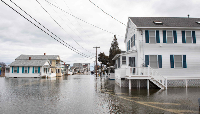 Homes are surrounded by flood waters in Hampton, New Hampshire on January 10, 2024. — AFP