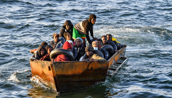 Migrants from sub-Saharan Africa sit in a makeshift boat off the coast of Tunisias city of Sfax. — AFP/File