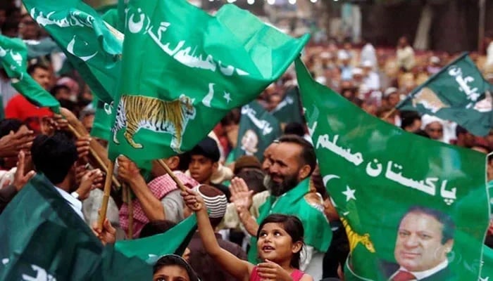 PMLN workers holding flags can be seen in this image.—AFP/File