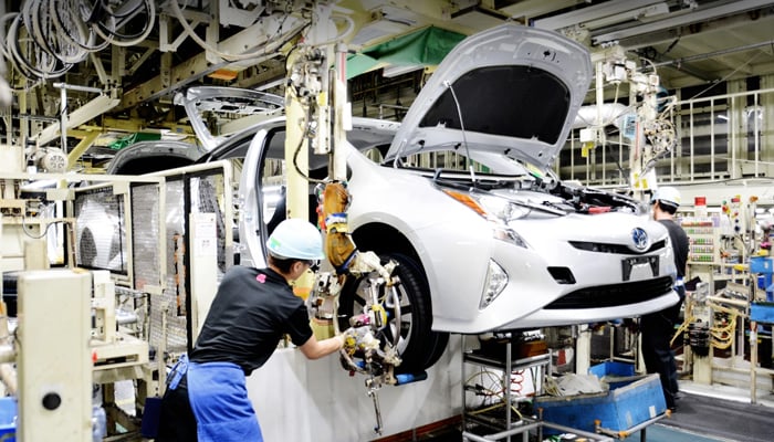 This image shows a worker while assembling a car in a Toyota assembly plant. — Toyota website