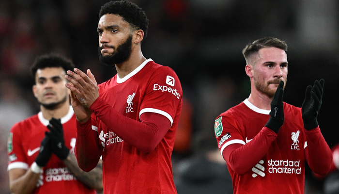 Liverpools Luis Diaz (L), Joe Gomez (C), and Alexis Mac Allister applaud the fans following the English League Cup semi-final first-leg football match against Fulham at Anfield in Liverpool on January 10, 2024. — AFP