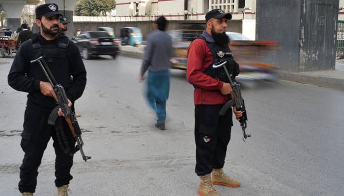 Police officials in Peshawar stand guard. — AFP/File