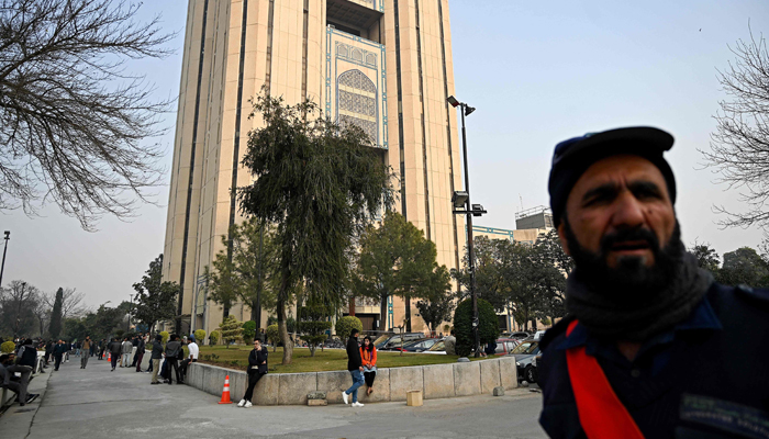 People gather outside a building in the aftermath of an earthquake in Islamabad on January 11, 2024. — AFP