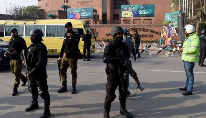 Security personnel stand guard ahead of the start of a cricket match, outside the Gaddafi Stadium in Lahore. — AFP/File