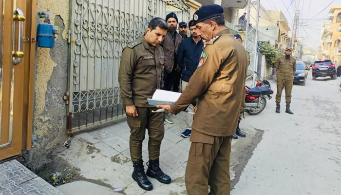 Police personnel of Rawalpindi police check documents during a survey in the city on January 8, 2024. — Facebook/Rawalpindi Police