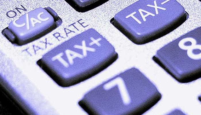 Tax can be seen written on the keypads of a calculator. — AFP/File