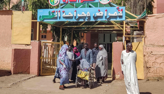 A patient is carted in a wheelchair outside Gedaref Nephrology Hospital in eastern Sudan on January 1, 2024. — AFP