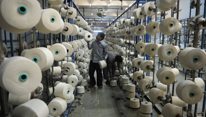 In this photo, a man can be seen working in a textile factory in Pakistan.—AFP/File