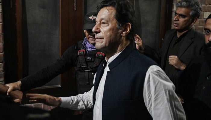 Former Pakistans Prime Minister Imran Khan (C) leaves after appearing at the high court in Lahore on March 17, 2023.—AFP