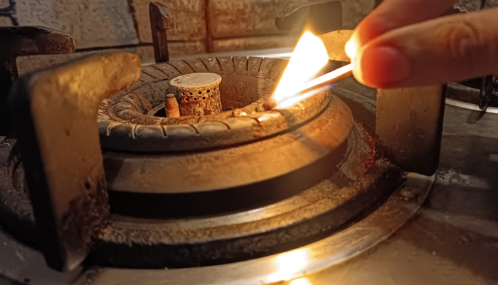 This image taken on January 15, 2024, shows a person lighting up a flame with a match stick in Karachis Gulshan Iqbal. — Geo.tv/Saad Aalam Angaria