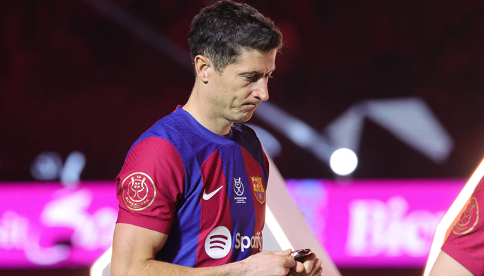 Robert Lewandowski walks during the medal ceremony after the Spanish Super Cup final football match between Real Madrid and Barcelona at the Al-Awwal Park Stadium in Riyadh, on January 14, 2024.—AFP