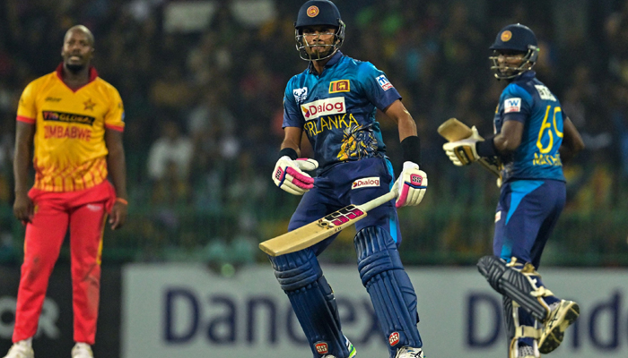 Sri Lankas Dasun Shanaka (C) and Angelo Mathews (R) run between wickets during the first Twenty20 international cricket match between Zimbabwe and Sri Lanka at the R. Premadasa Stadium in Colombo on January 14, 2024. — AFP