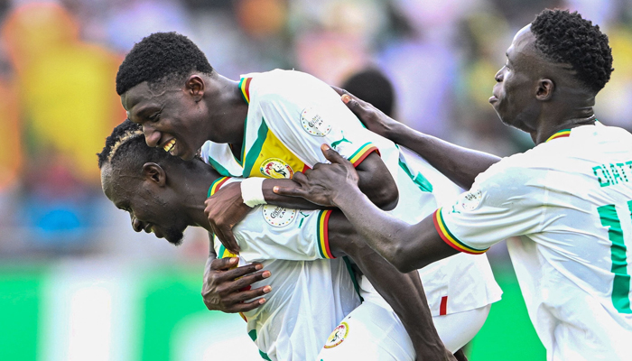 Lamine Camara (C) celebrates with teammates after scoring his team´s third goal during the Africa Cup of Nations (CAN) 2024 group C football match between Senegal and Gambia at Stade Charles Konan Banny in Yamoussoukro on January 15, 2024.— AFP