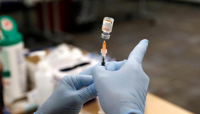 A nurse practitioner fills a syringe with the Pfizer Covid-19 vaccine to be administered to children at the Beaumont Health offices in Southfield, Michigan on November 5, 2021. — AFP