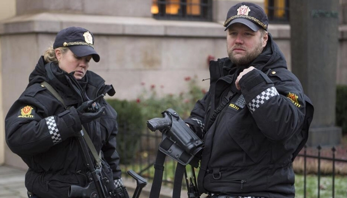 Armed police officers are seen outside the Nobel Institute in Oslo on December 9, 2014. — AFP