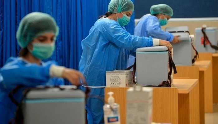 Medical attendants prepare to vaccinate people at a vaccination center in Karachi, Pakistan, on February 3, 2021. — AFP