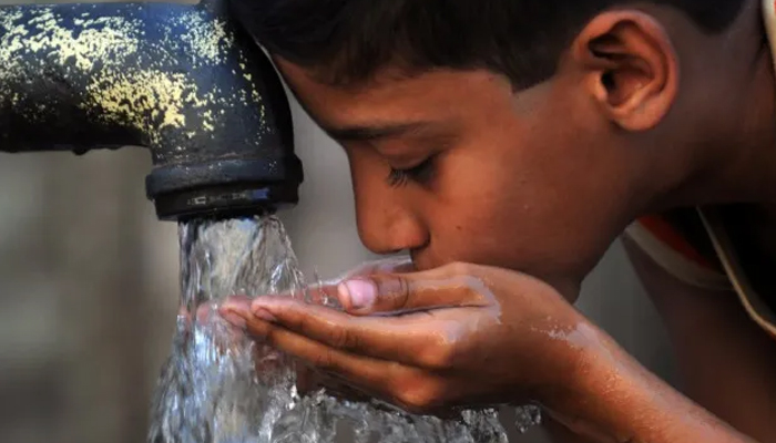 This image shows a child drinks water from a tap. — AFP/File
