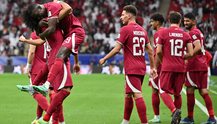 Qatars Akram Afif (L) celebrates with teammates after scoring his teams first goal during the Qatar 2023 AFC Asian Cup Group A football match between Tajikistan and Qatar at the Al-Bayt Stadium in Al Khor, north of Doha on January 17, 2024. — AFP