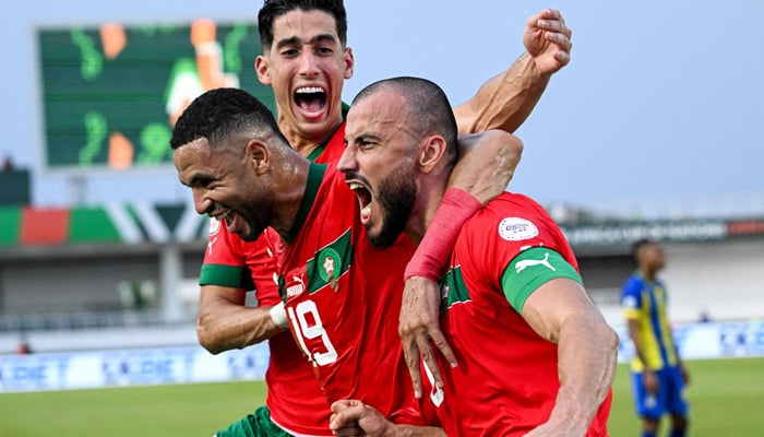 Moroccos Romain Saiss (R) celebrates with Youssef En-Nesyri (C) and Nayef Aguerd (L) after scoring his teams first goal during the Africa Cup of Nations 2024 group F football match between Morocco and Tanzania at Stade Laurent Pokou in San Pedro on January 17, 2024. — AFP
