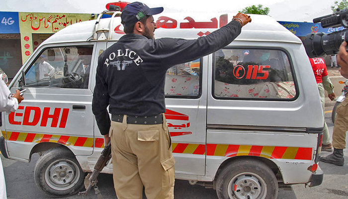 Police official makes way for an ambulance in KP. — AFP/File