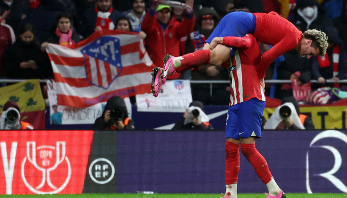 Atletico Madrids Antoine Griezmann is lifted by Atletico Madris Jose Gimenez after scoring his teams third goal during the Spanish Copa del Rey (Kings Cup) football match between Club Atletico de Madrid and Real Madrid CF at the Metropolitano stadium in Madrid on January 18, 2024. — AFP