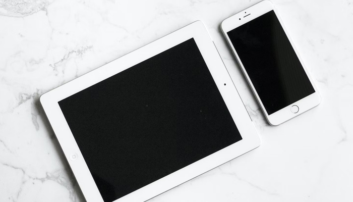 A representational image shows a tablet along with a smartphone. — Unsplash