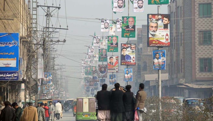A view of different political parties banners displayed on street lights for upcoming General Election-2024 at Dalazak Road on January 19, 2024. — APP