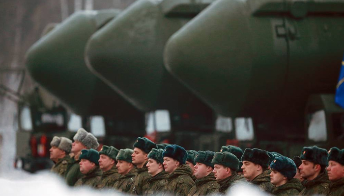 Russian nuclear warheads can be seen in the background with the Russian army soldiers standing guard. — Tass/File