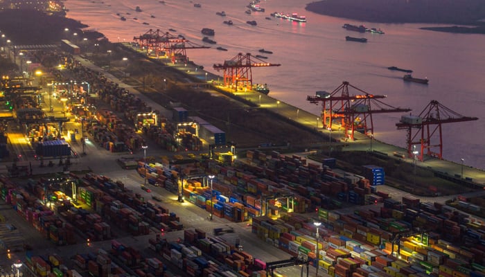 The aerial photo taken on January 4, 2023, shows shipping containers stacked at Nanjing port in Chinas eastern Jiangsu province. — AFP
