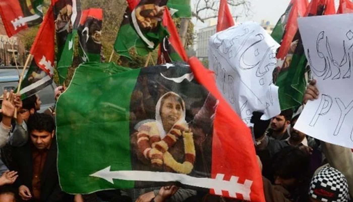 PPP workers carry flags and banners during a party rally. — AFP/File