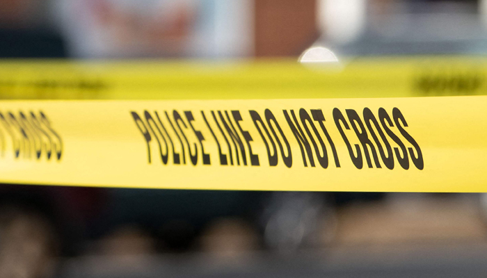 Police tape surrounds the area near a home on December 5, 2023. — AFP