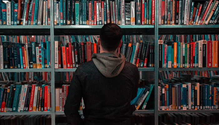 This representational image shows a student collecting a book in the library. —Unsplash