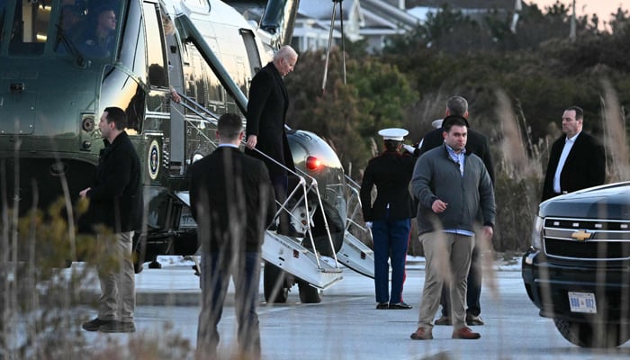 US President Joe Biden steps off of Marine One upon arrival at Gordons Pond in Cape Henlopen State Park in Rehoboth Beach, Delaware on January 21, 2024. — AFP