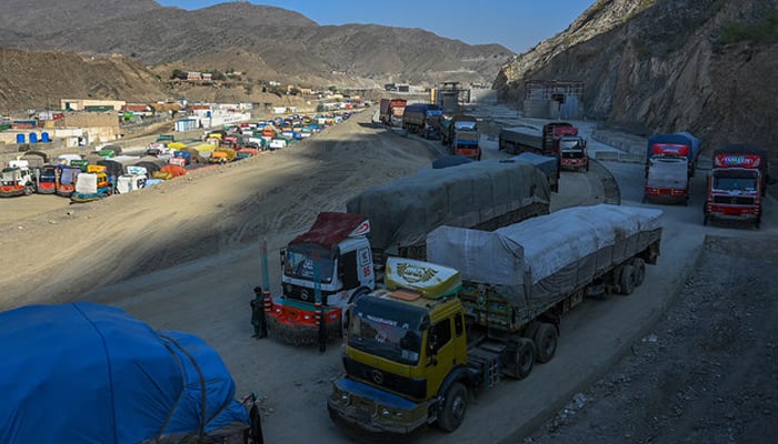 In this picture, trucks are seen parked along a road and a parking area near the Pakistan-Afghanistan border in Torkham on September 11, 2023. — AFP