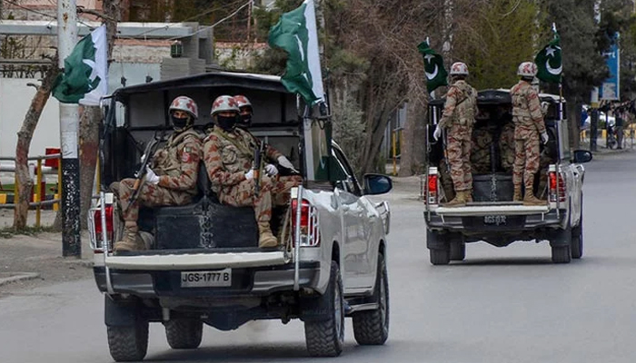 Security personnel patrol with vehicles on a street in Quetta, Pakistan, on March 25, 2020. — AFP