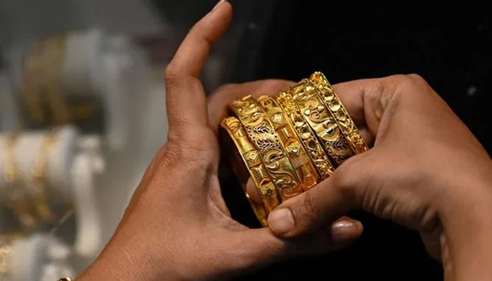 An undated image of a customer looking at the gold bangles at a store. — AFP/File