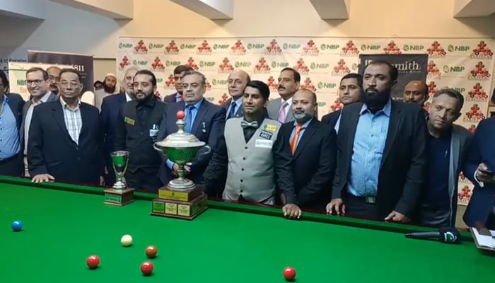 Pakistani snooker player Asjad Iqbal stands with the trophy after winning the National Snooker Championship. — Facebook/Rocket Snooker Factory