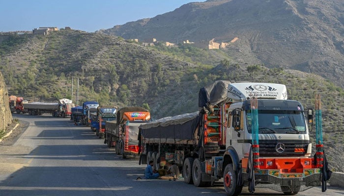 Trucks are seen parked along a road near the Pakistan-Afghanistan border in Torkham on September 11, 2023, after the Torkham border closed on September 6, 2023, following clashes between border forces of both countries. — AFP