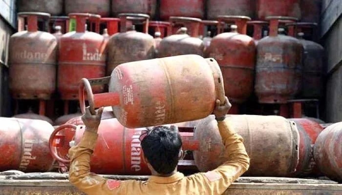 A worker can be seen loading the LPG cylinder. — AFP/File
