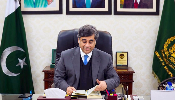 Dr. Gohar Ejaz sits and looks on to the Holy Quran as he assumes the charge as Caretaker Federal Minister of Interior in Islamabad on January 24, 2024. — INP